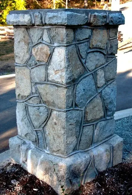 Natural stone entry pillar with a cut stone cap