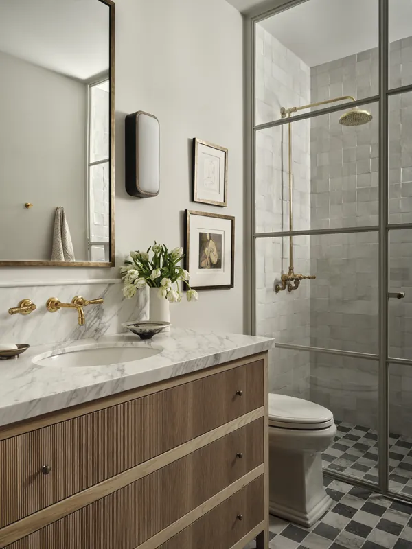 Farmhouse bathroom with a fluted vanity, steel framed shower and checkerboard floor