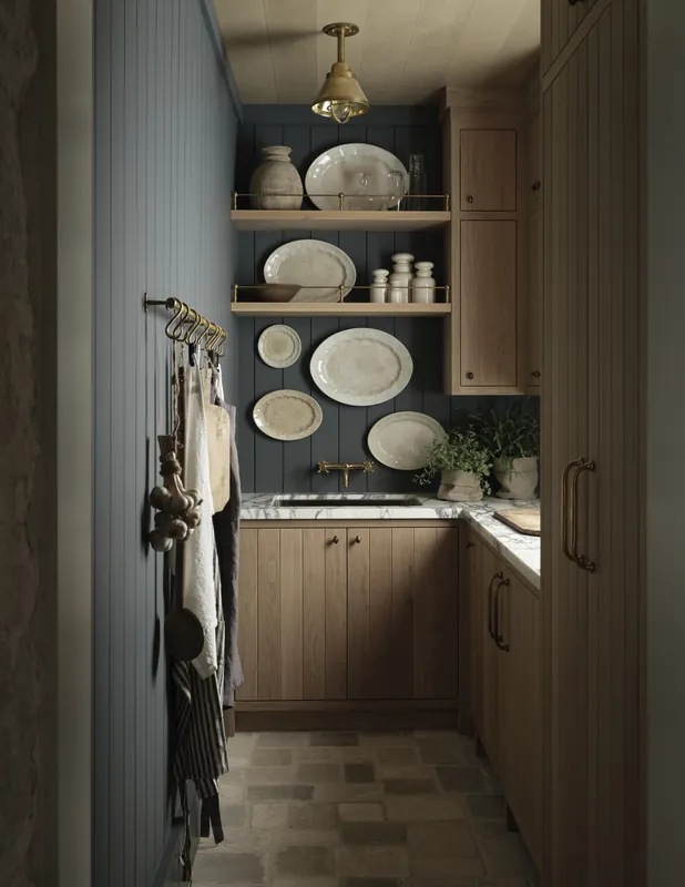 Farmhouse pantry with oak cabinets, open shelving and a clay tile floor