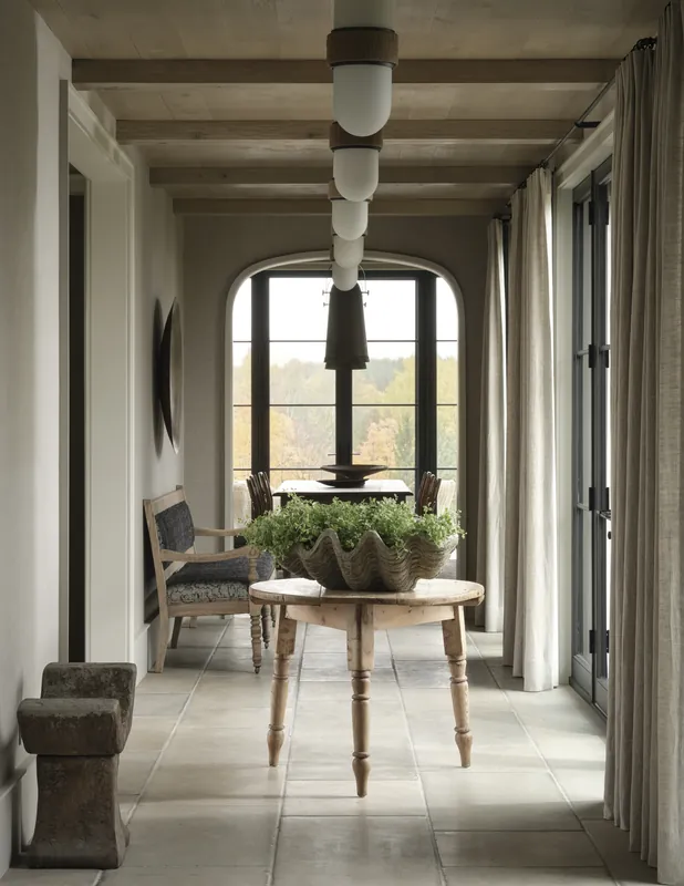 Farmhouse hallway with a stone tile floor and an arched window