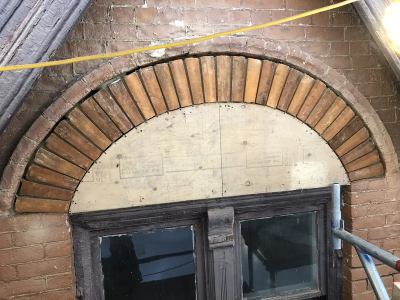 Brick arch rebuilt over the original window on a Toronto home