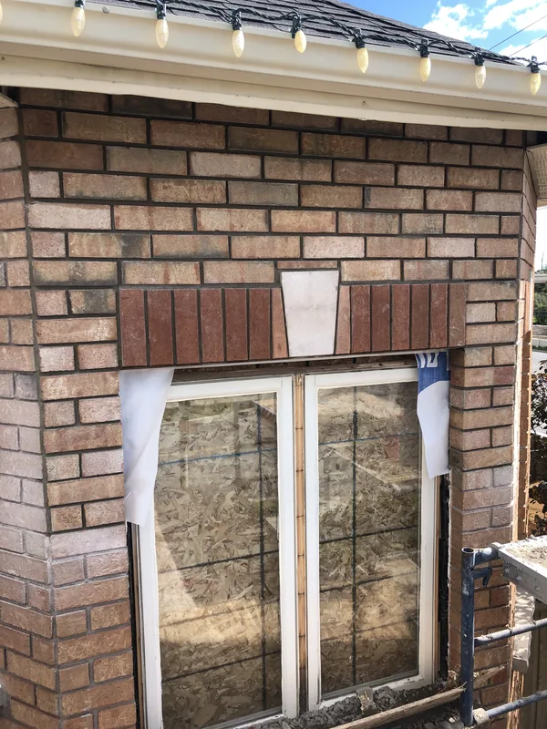 New opening in a brick wall finished with a brick header and stone keystone in Whitby
