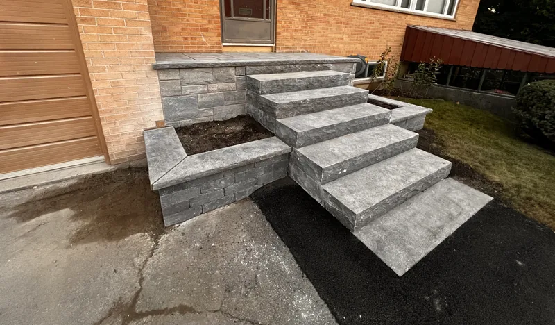 Rebuilt front steps with solid stone treads and planter walls in Oshawa