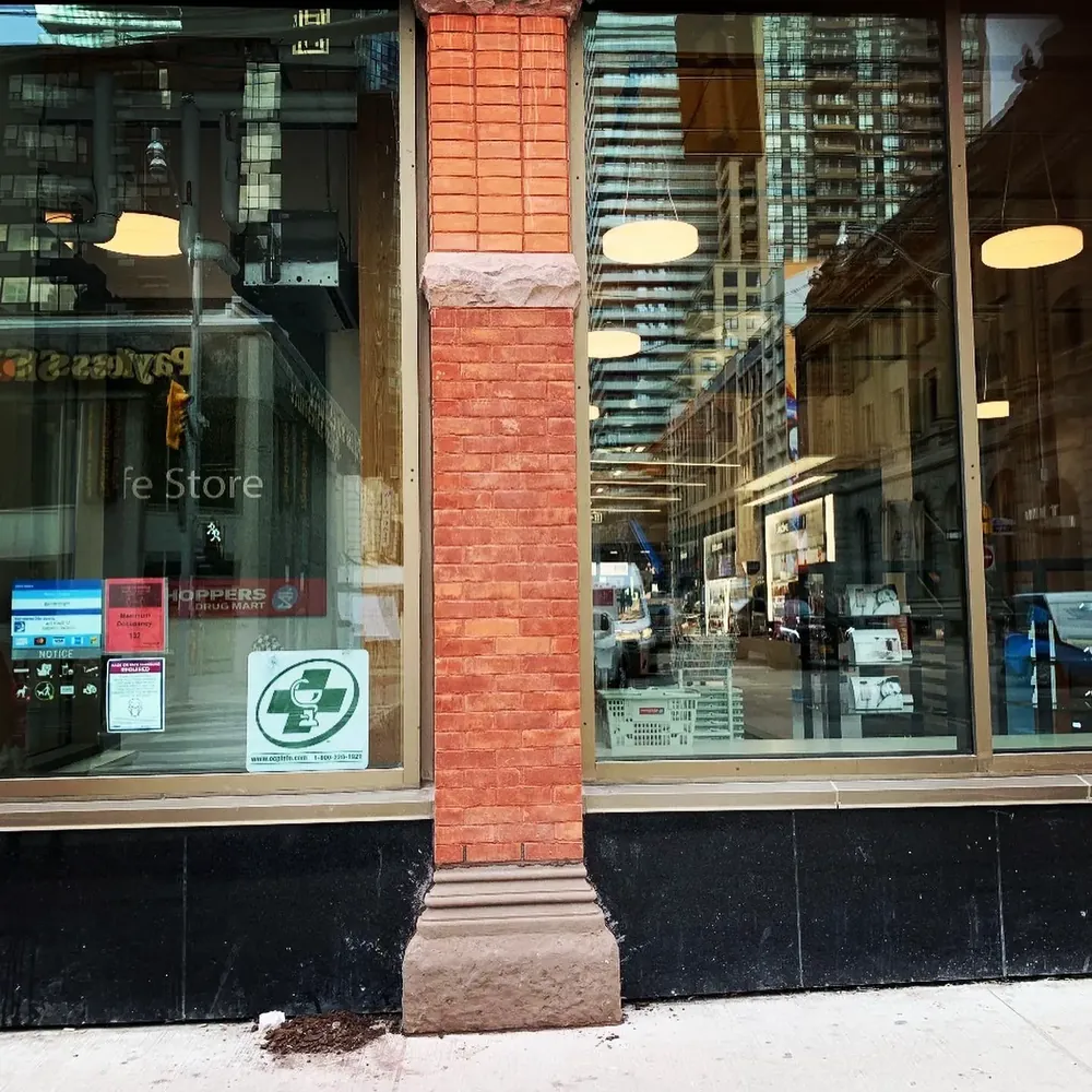 Restored brick and stone pilaster on a commercial storefront