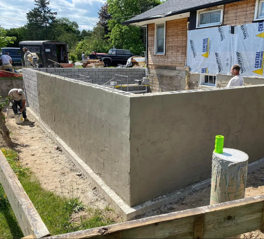Parged concrete block foundation wall on a new build